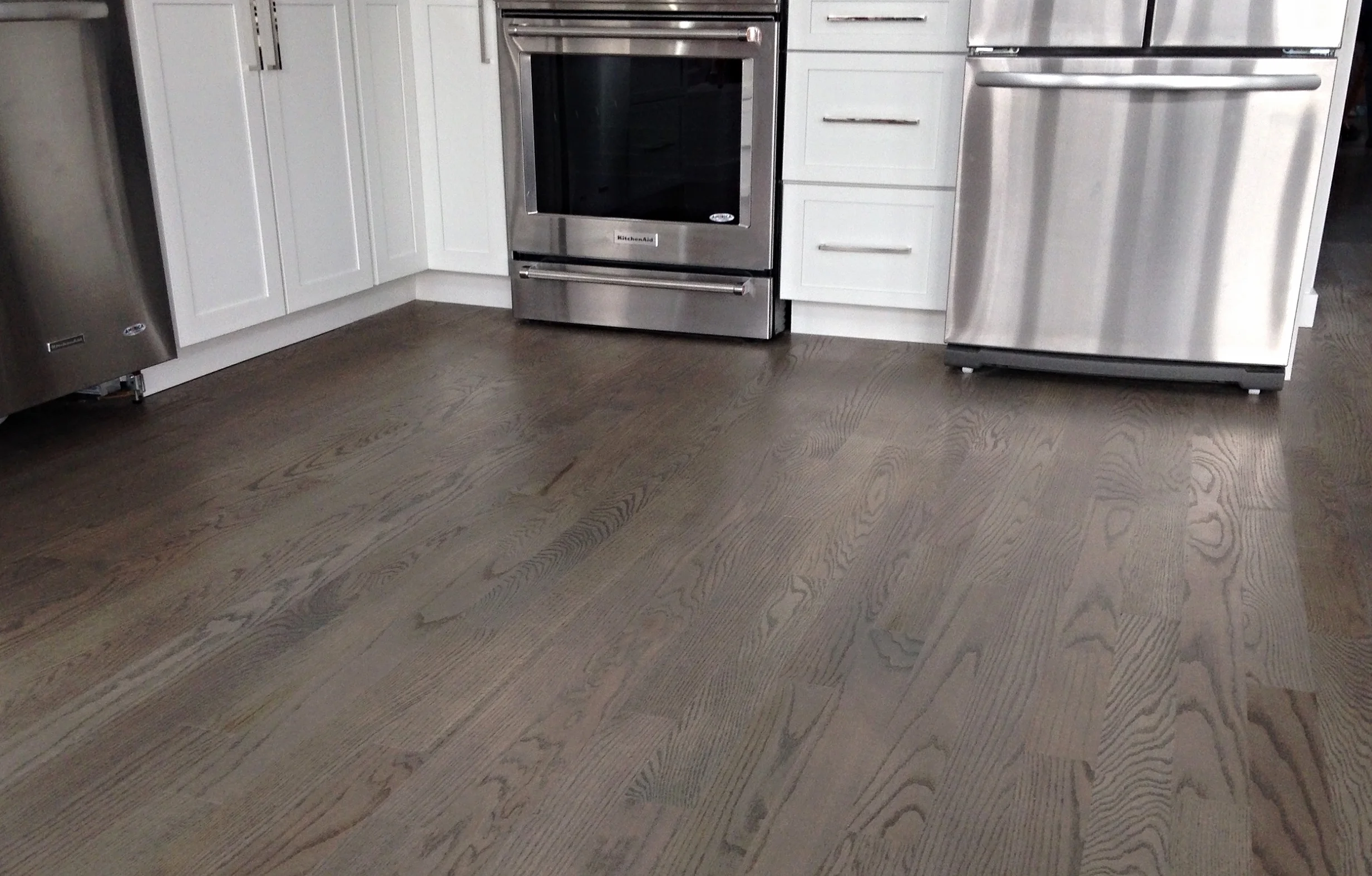 Gray-stained oak hardwood flooring in a modern kitchen