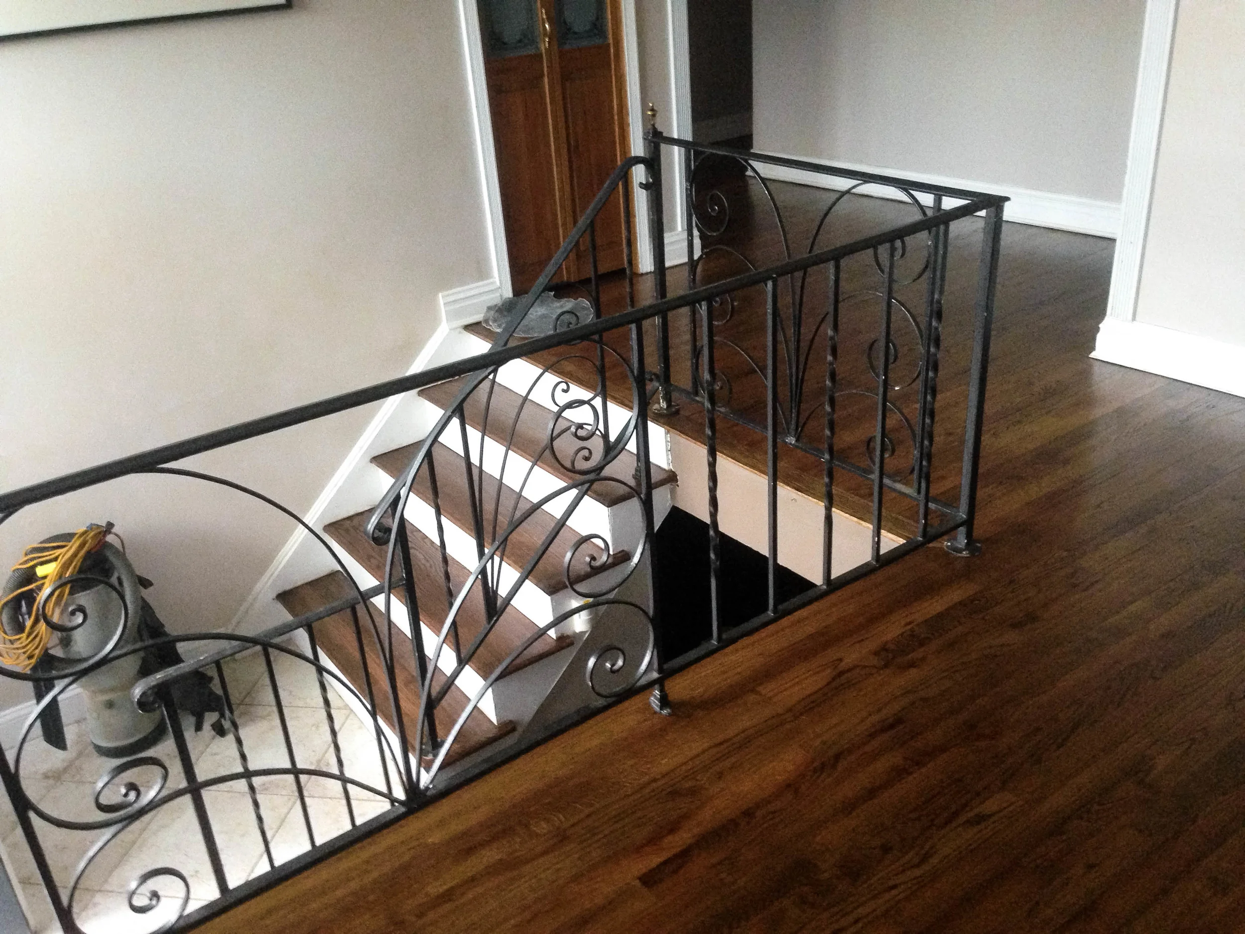 Dark walnut-stained hardwood flooring on a staircase landing
